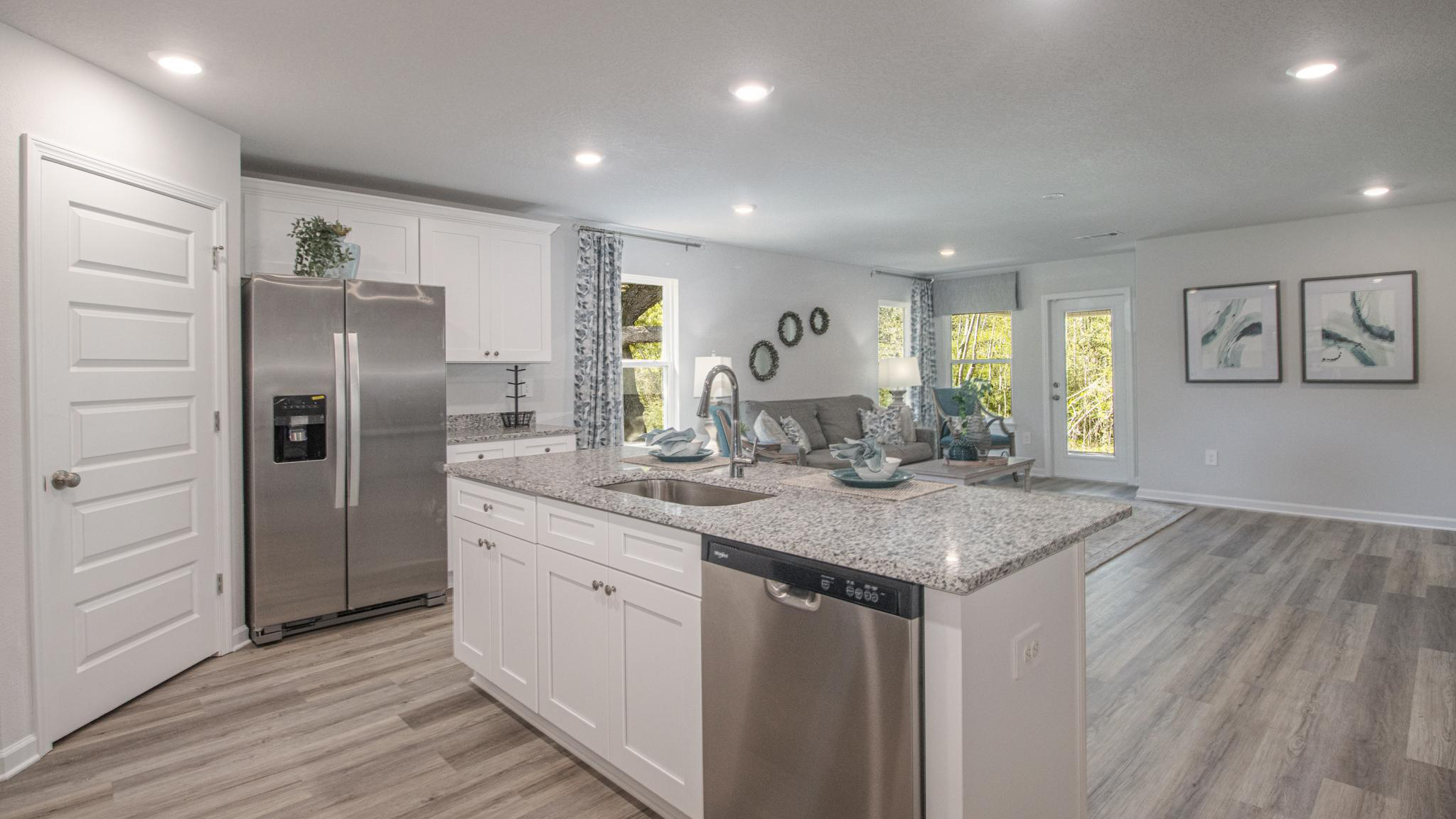 The kitchen with white shaker-style cabinetry and stainless-steel appliances.
