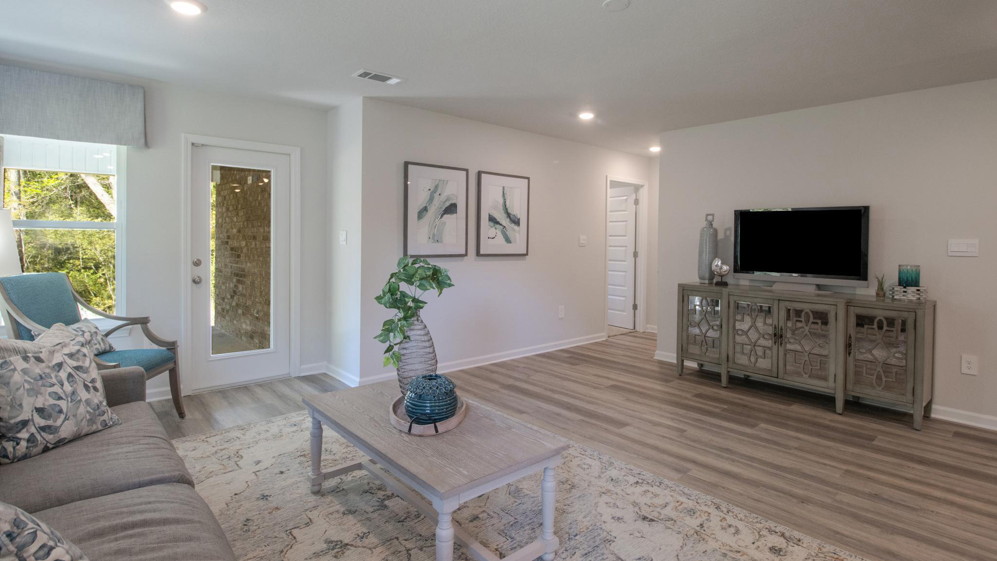 The living room with a patio door leading to covered porch.