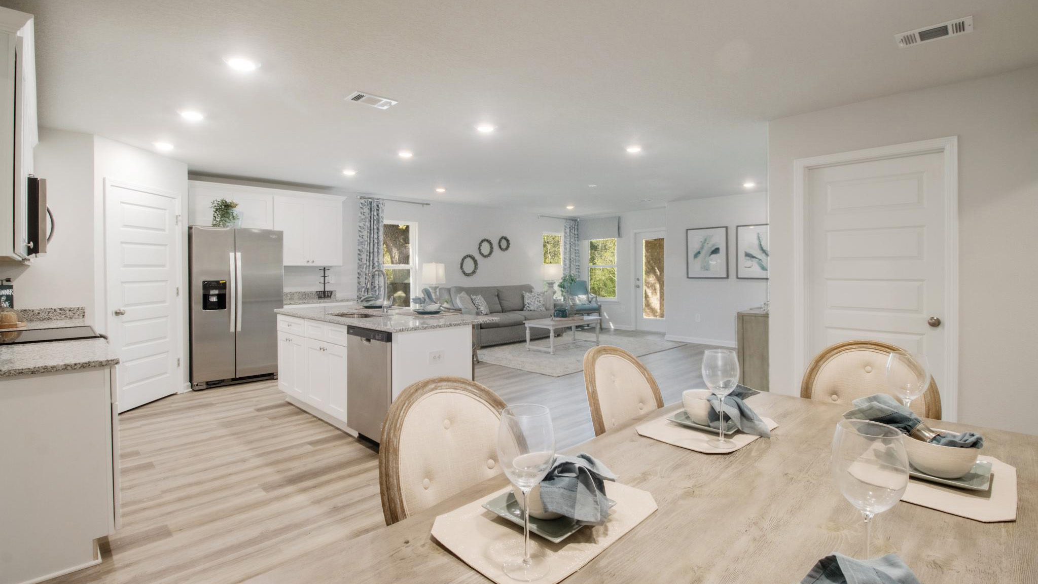 Dining room with views into kitchen and living area.