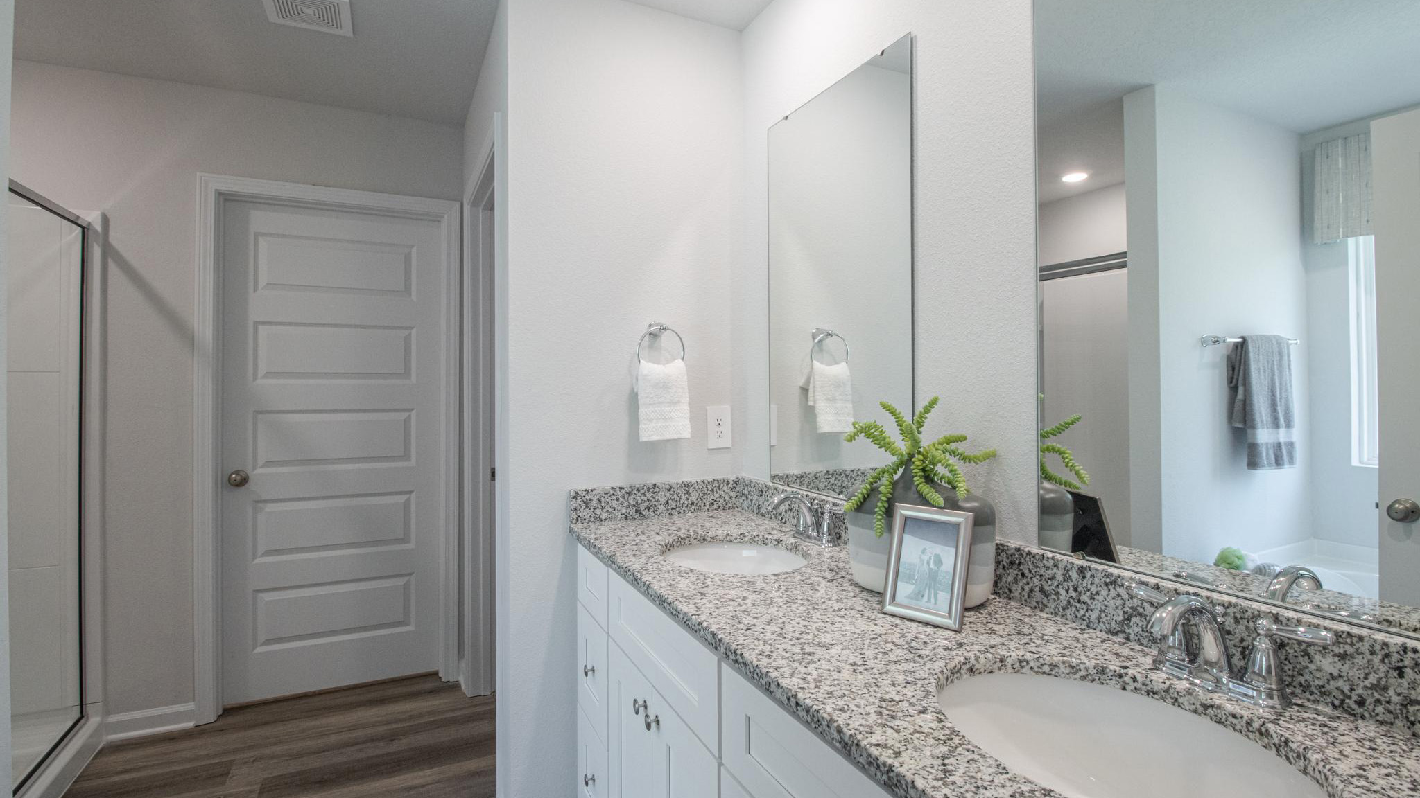 Primary ensuite with dual sink vanity.
