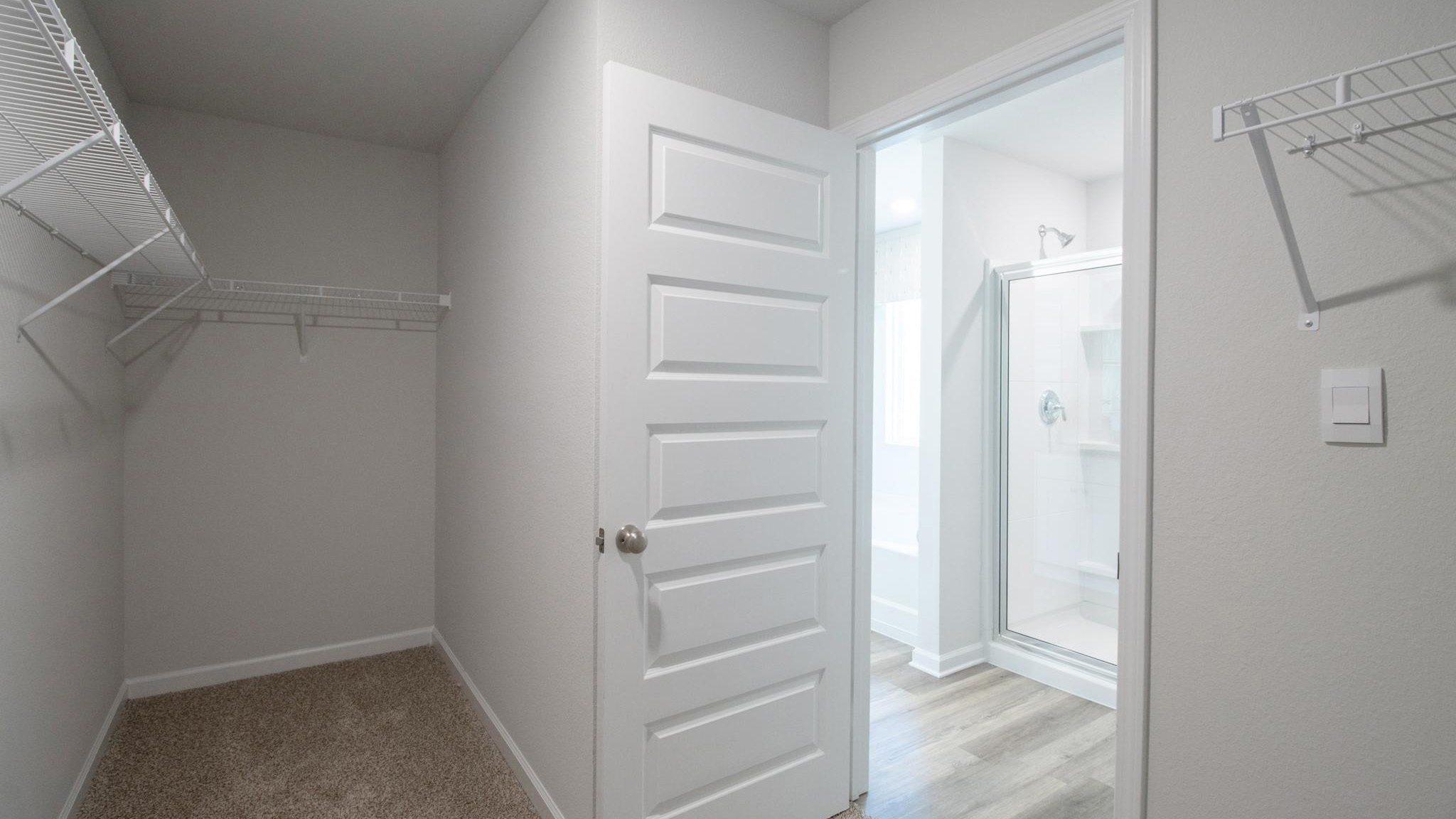 Primary walk-in closet with wire shelving.