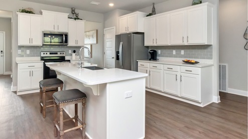 Spacious kitchen with single standing island.