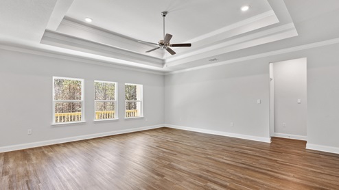 Bright and spacious living area that leads to primary suite
