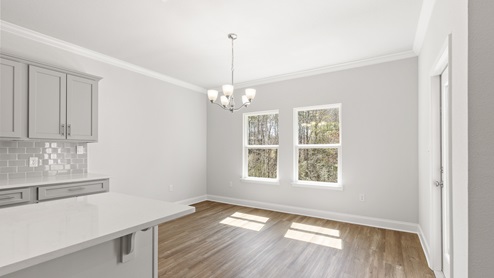 Bright and airy dining area aside kitchen
