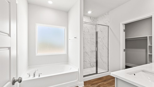 Luxurious and bright primary bathroom suite