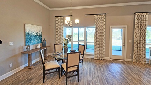 Breakfast area with windows and patio door to covered porch.