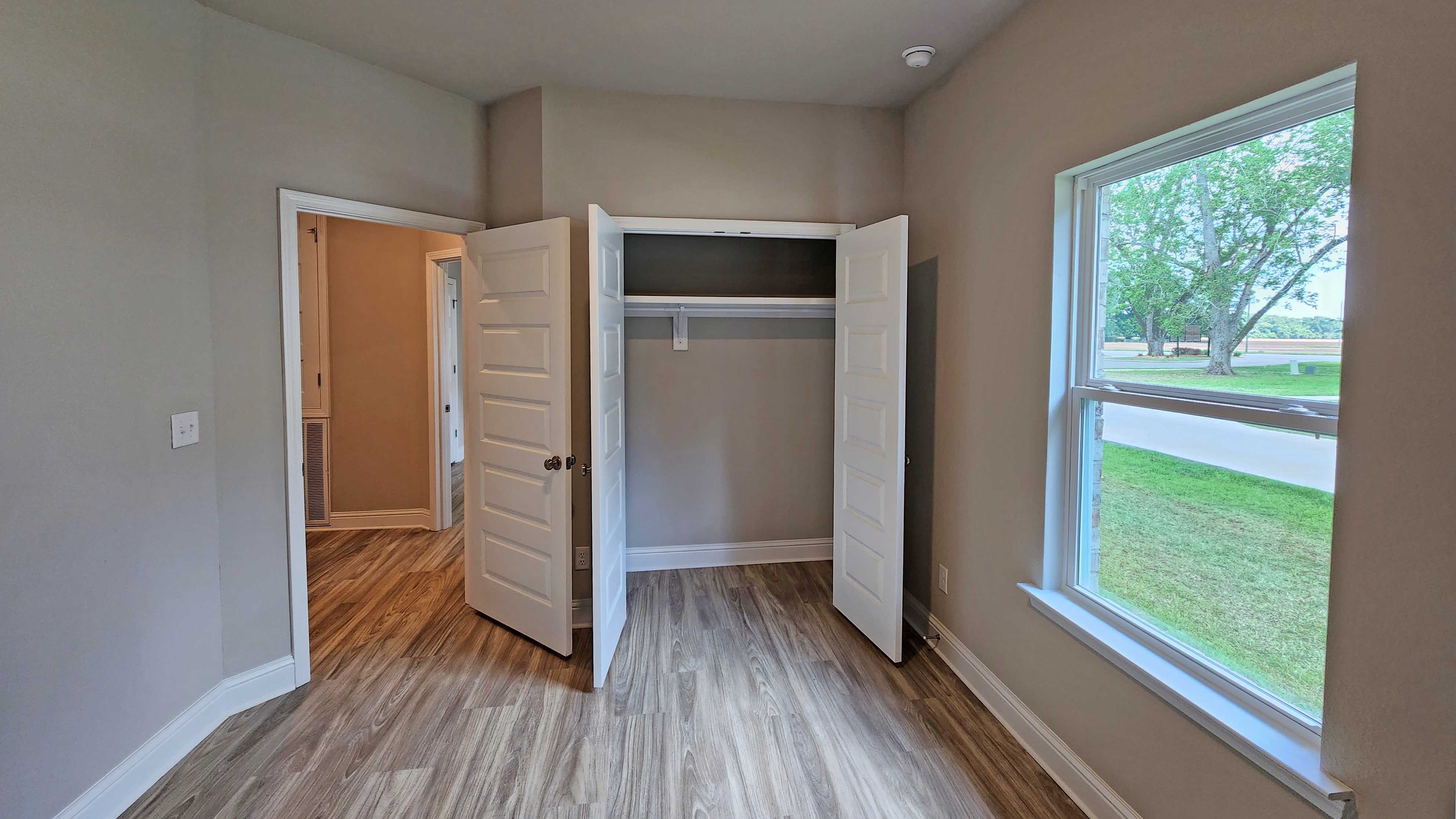 Naturally lit bedroom with spacious closet area