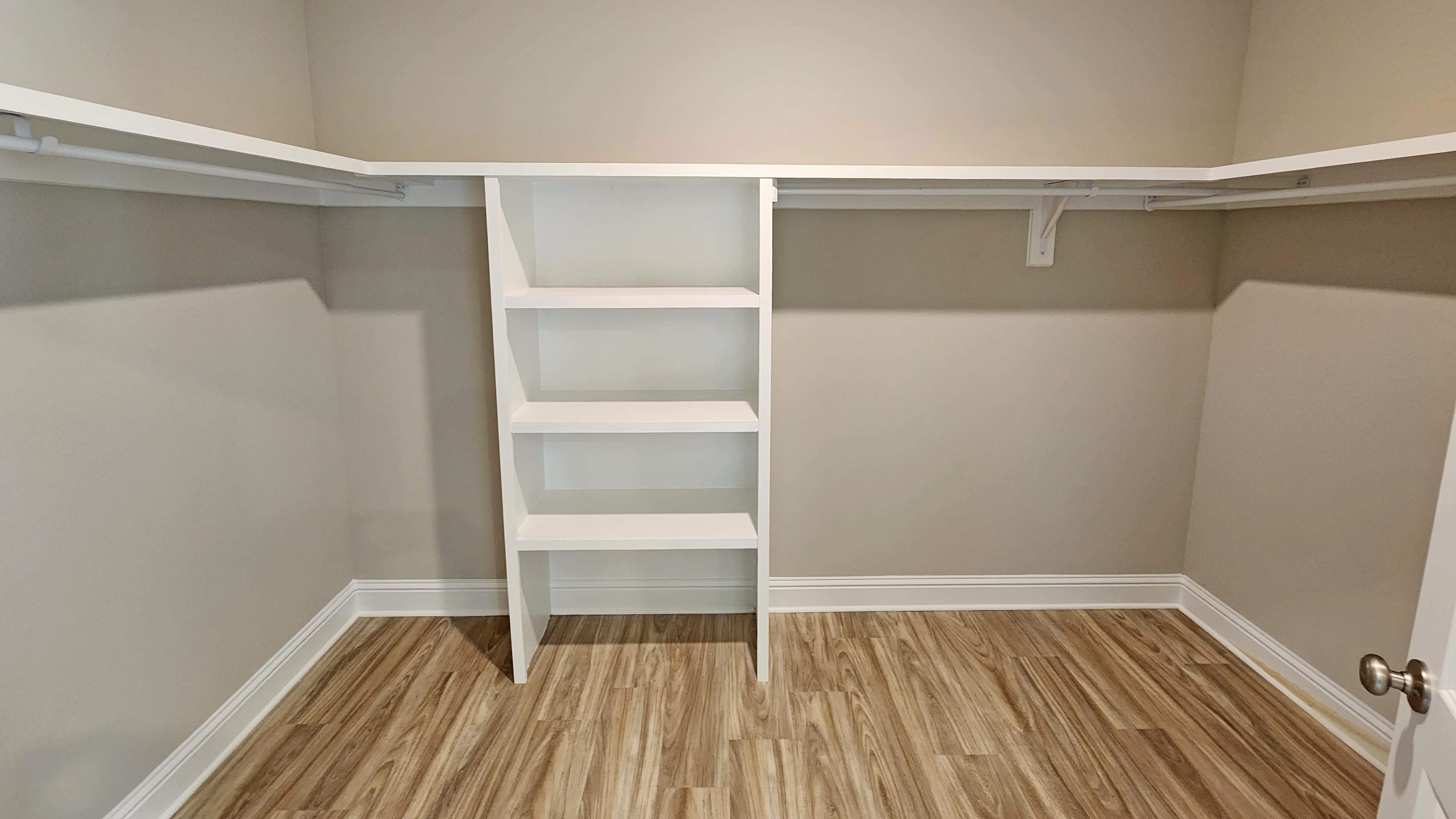 Walk in closet attached to primary bedroom suite