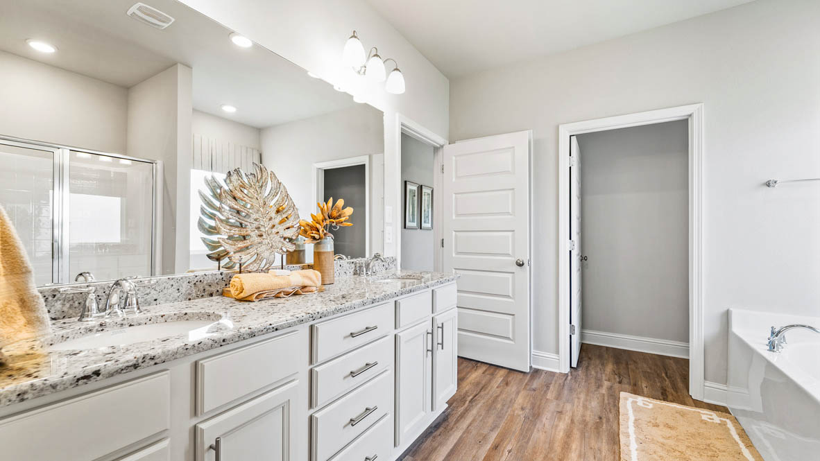 Primary ensuite with dual sink vanity with separate water closet.