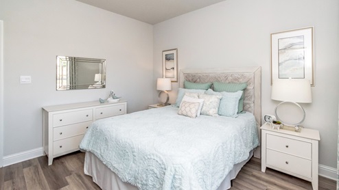 Beautiful additional bedroom accented with soft blue colors.