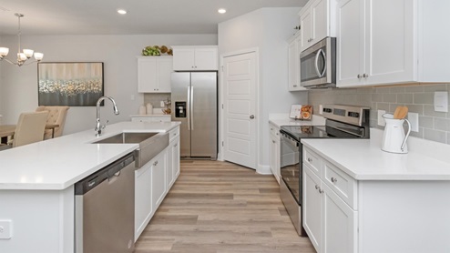 Side shot of the open, bright kitchen.