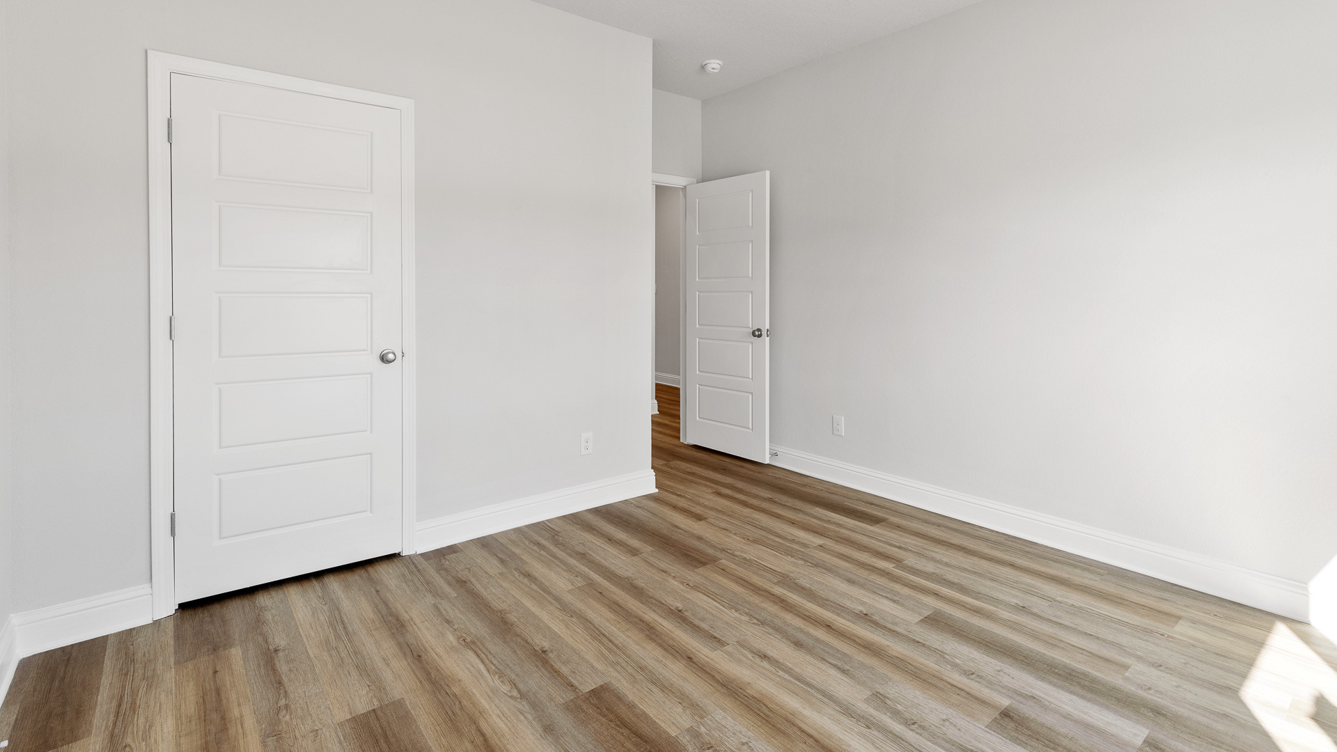 Primary bedroom with ensuite bathroom and luxury vinyl plank flooring in Hawkins Manor.