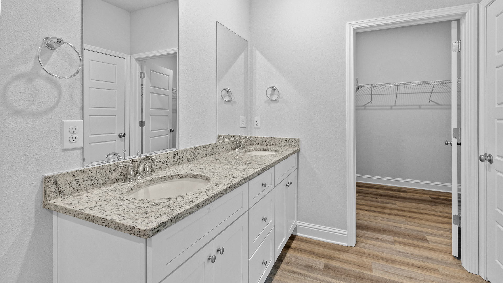 Ensuite primary bathroom with large walk in closet.