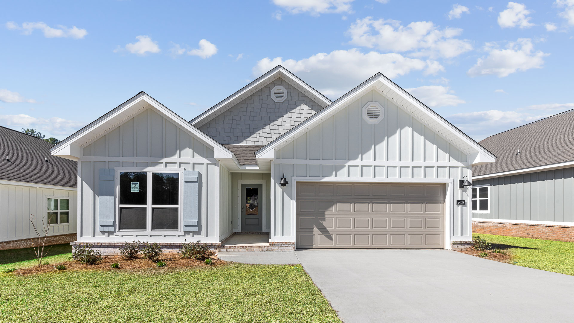 New construction home built by D.R. Horton with hardie plank and brick veneer.