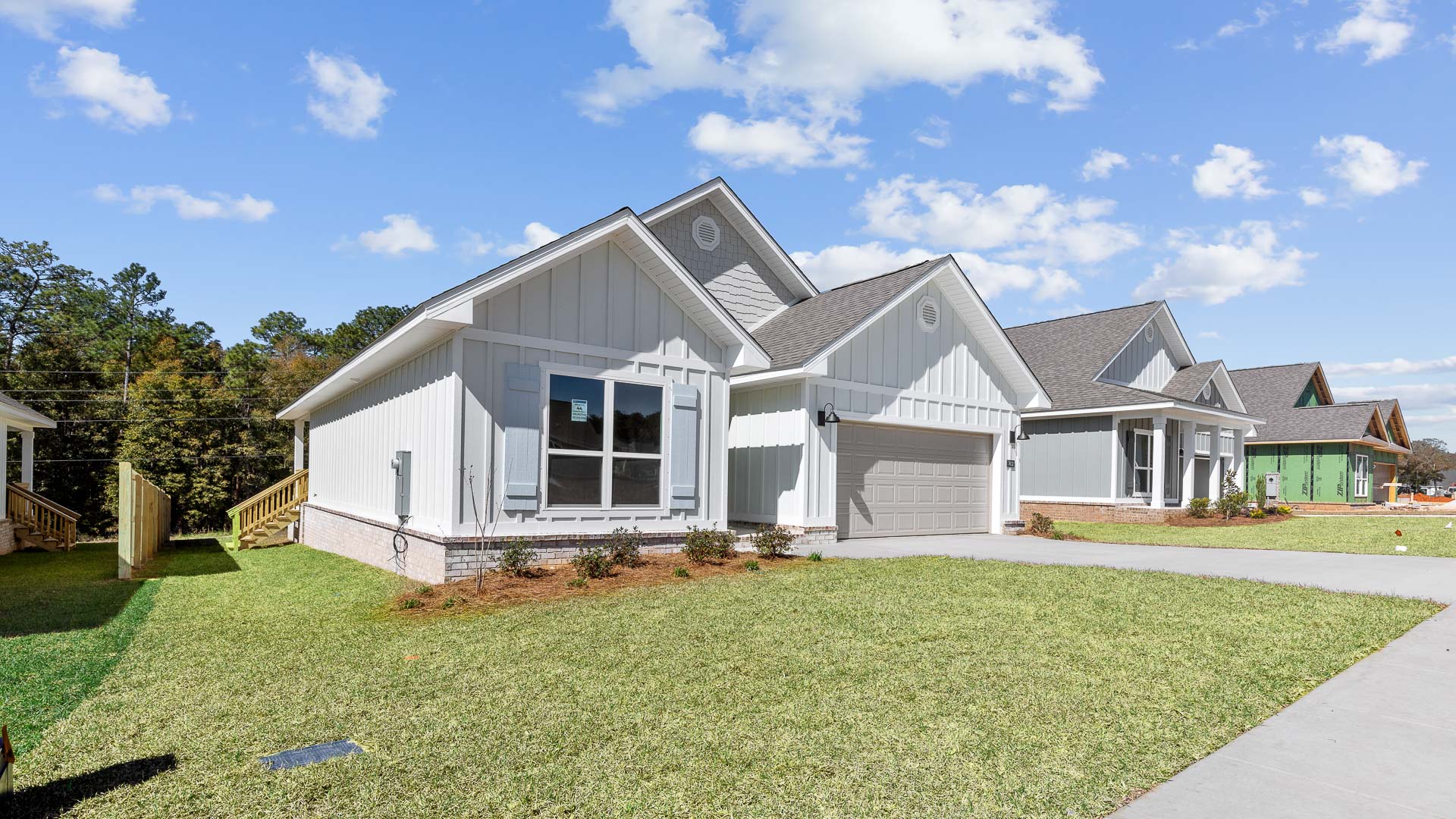 Front exterior elevation of the Arlington with manicured lawn and driveway in Mobile.