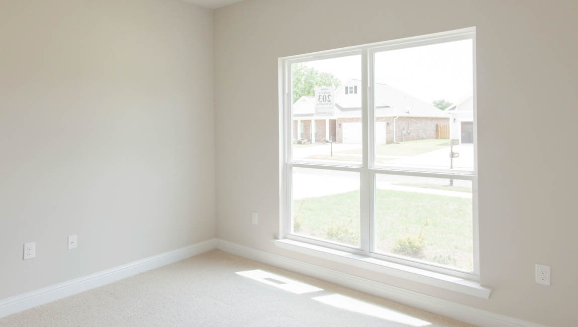 Bright and airy guest bedroom with natural light in a new home in Hawkins Manor.