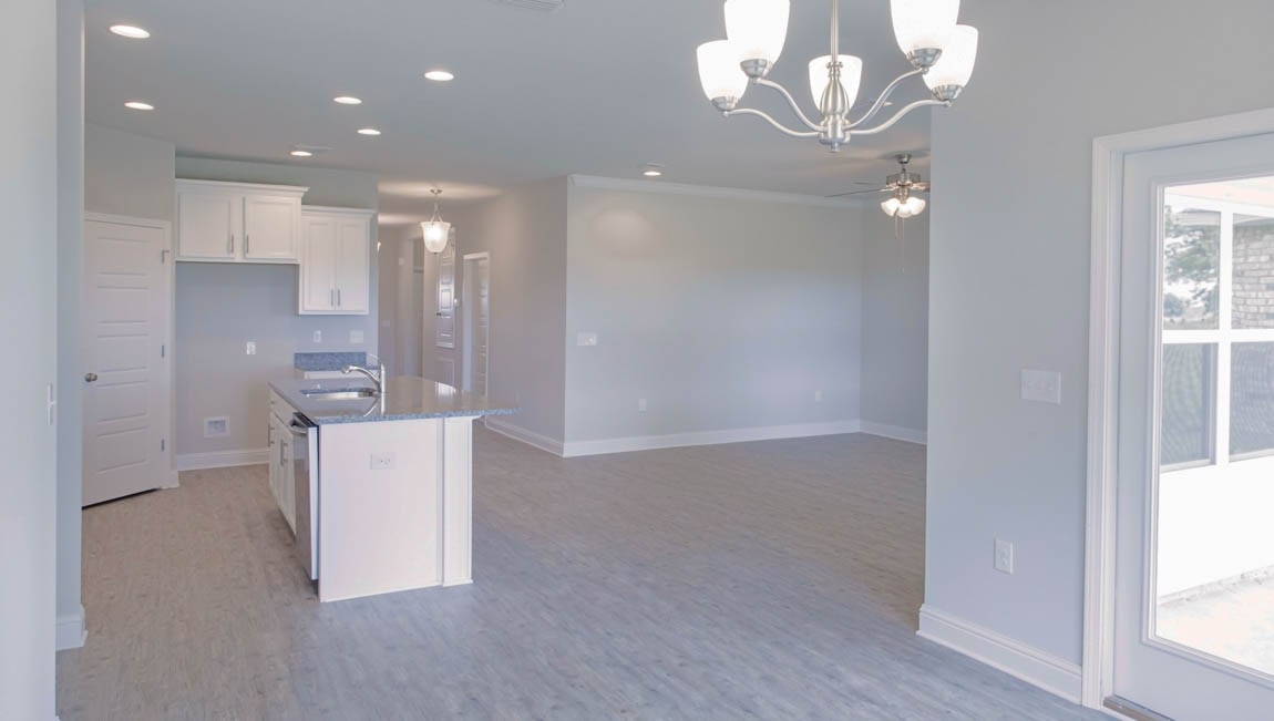 Open-concept kitchen and dining area with natural light in a new DR Horton home.