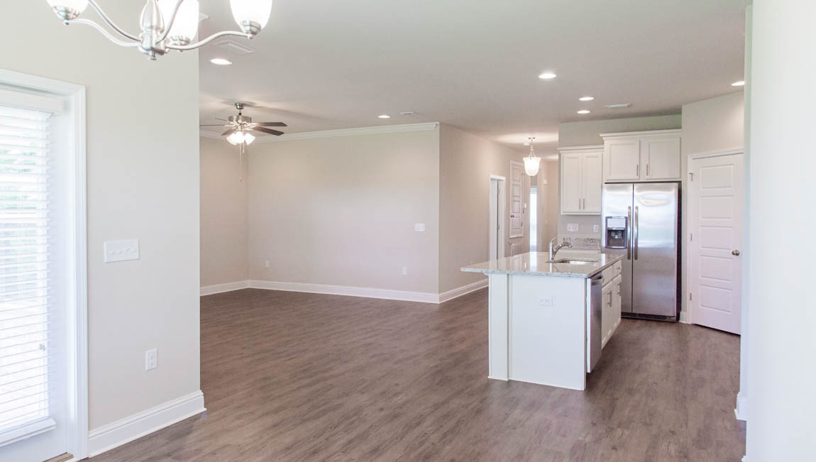 Open concept floorplan with kitchen family room view in a new D.R. Horton home.