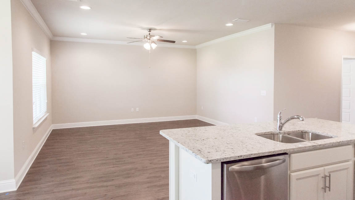 Inviting family room with ceiling fan and high ceilings in Mobile County.