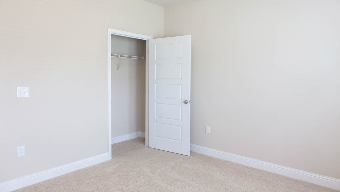 Spacious guest bedroom in the Bristol floorplan in Mobile County.