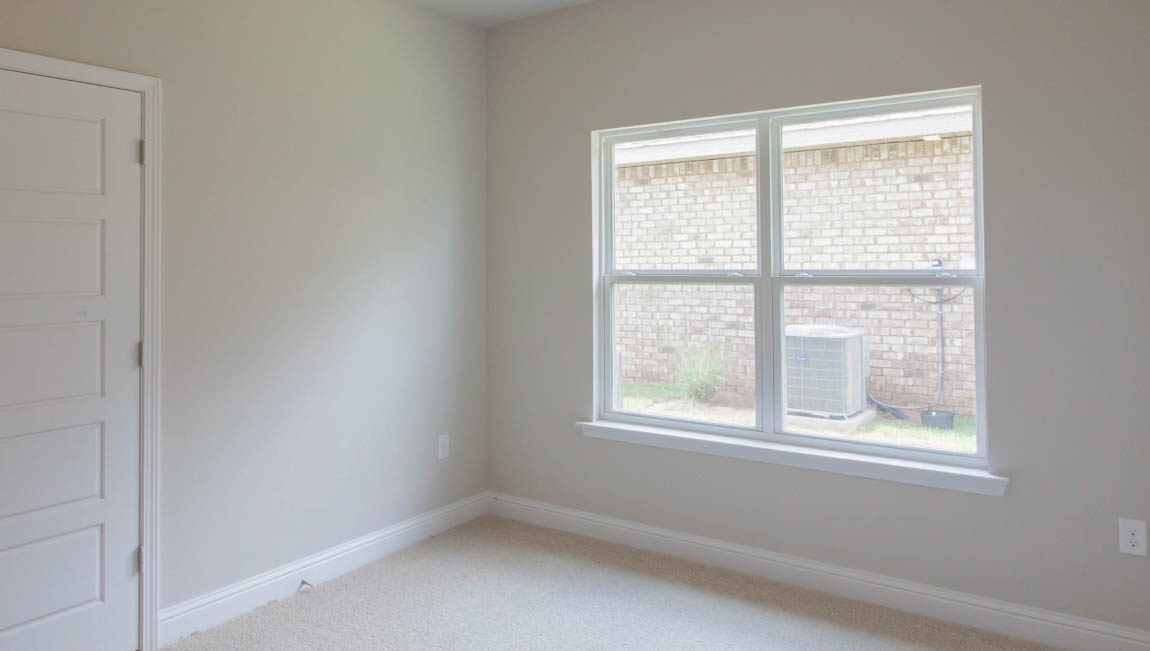 Guest bedroom large enough for full size bed in a new D.R. Horton home.