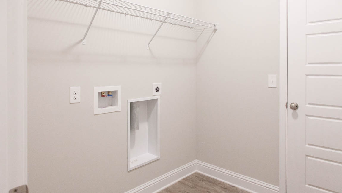 Functional laundry space with washer and dryer hook up in Hawkins Manor.