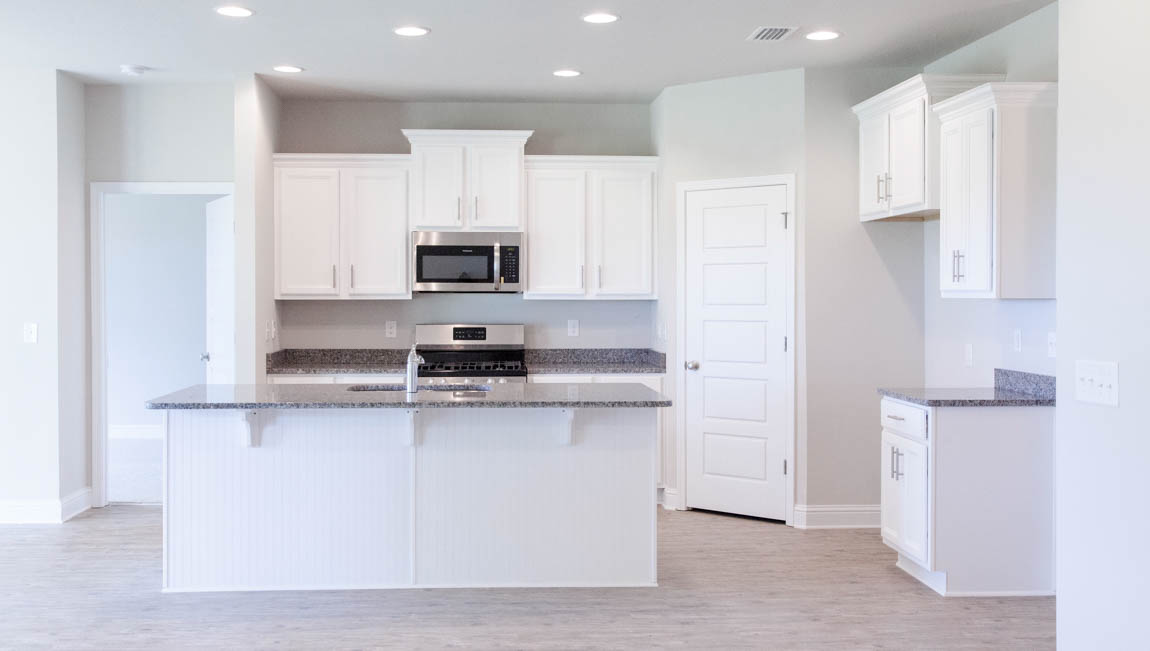 Sleek kitchen with lots of cabinets for storage and granite countertop in Hawkins Manor.