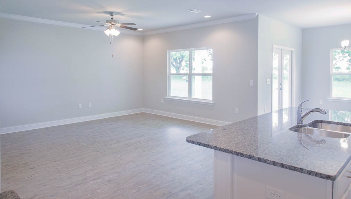 Open family room with kitchen view and lots of windows for natural light in Hawkins Manor.