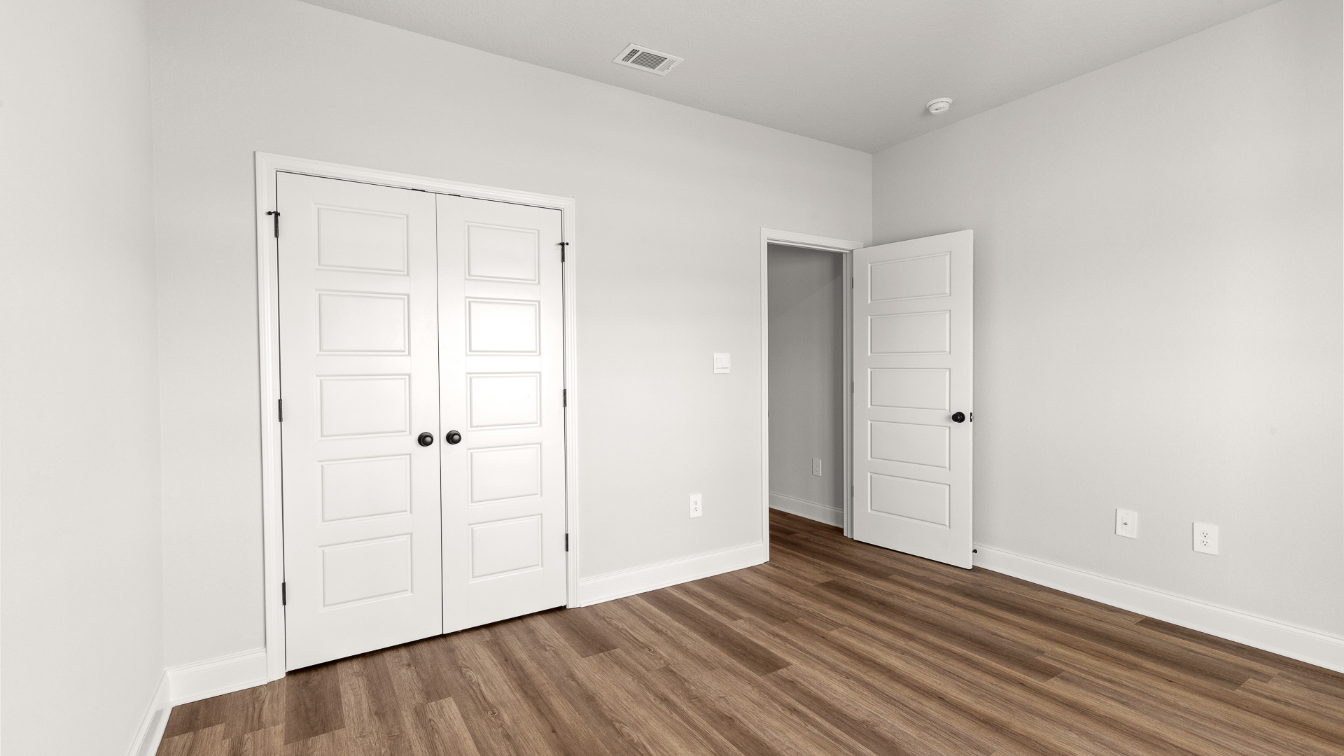 Guest bedroom with closet and recessed lighting in Hawkins Manor.