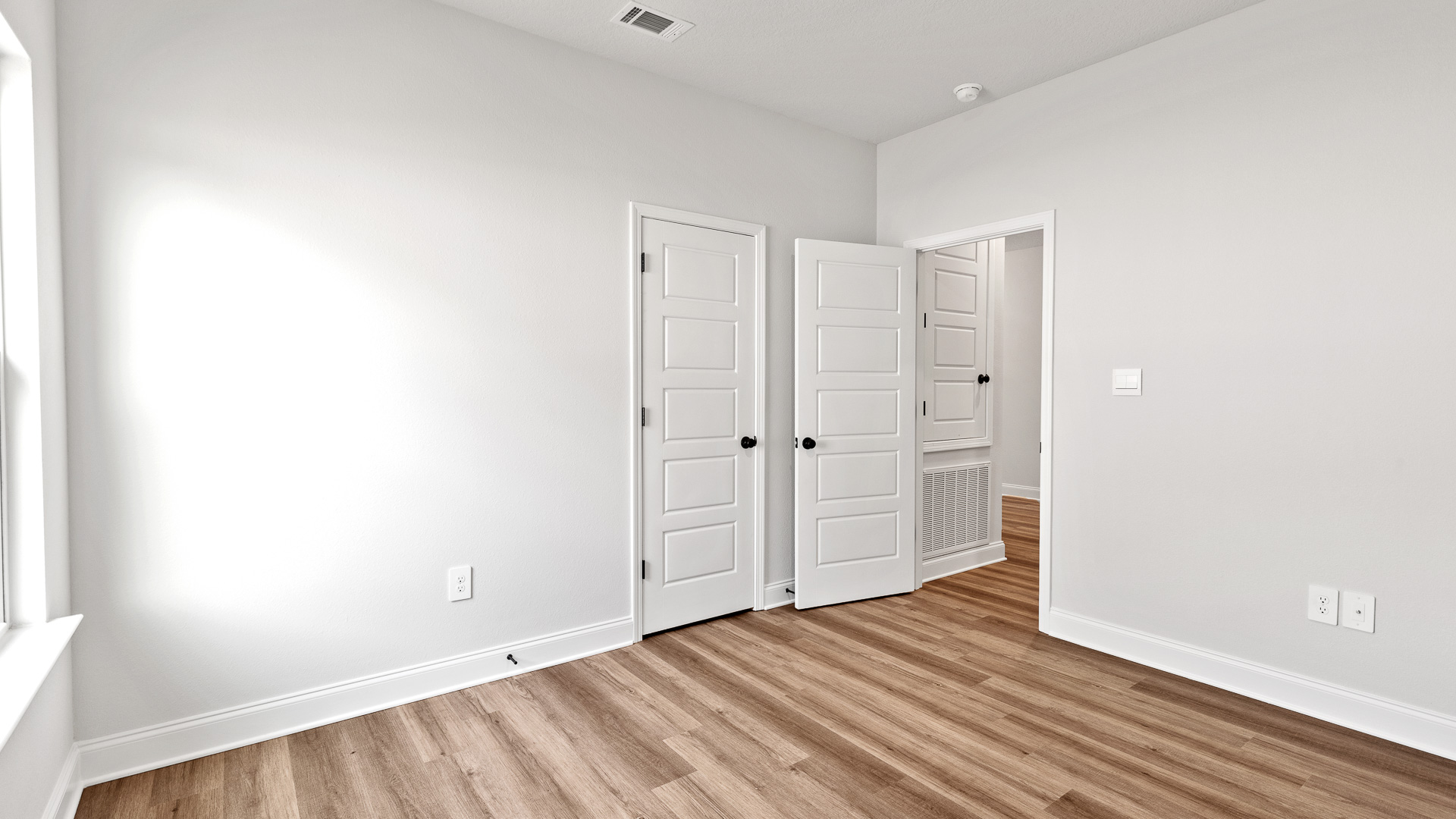 Guest bedroom with recessed lighting and luxury vinyl plank flooring in Mobile.