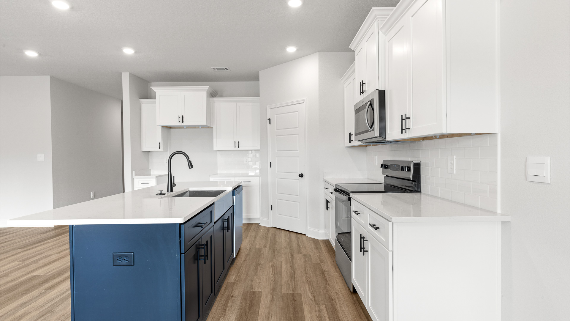 Spacious kitchen with central island and stainlesss steel appliances in Mobile.