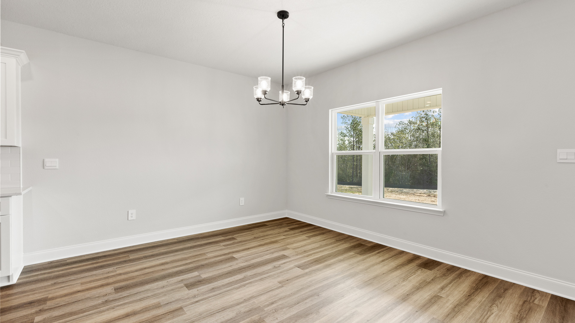 Light and airy dining area with hanging light fixture.