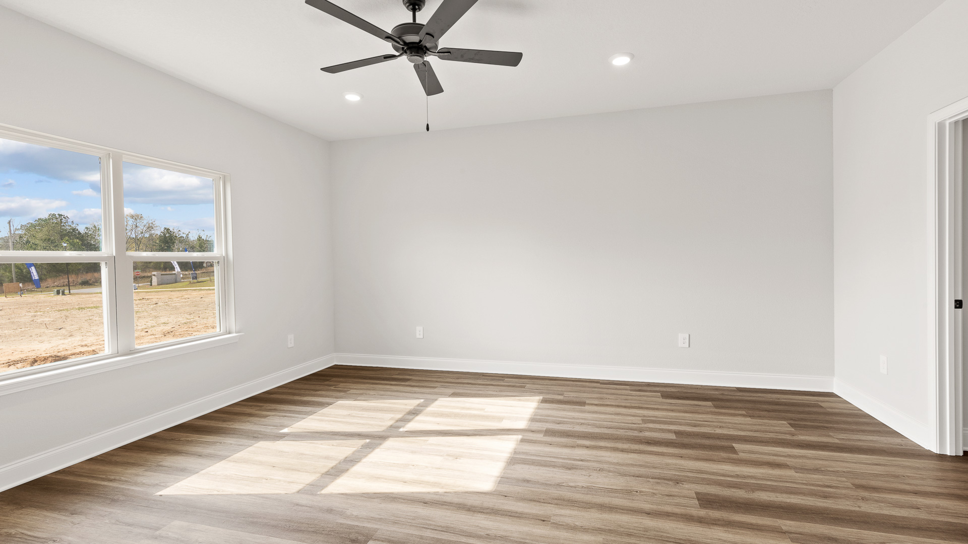 Spacious primary suite with large windows for natural light in a new D.R. Horton home.