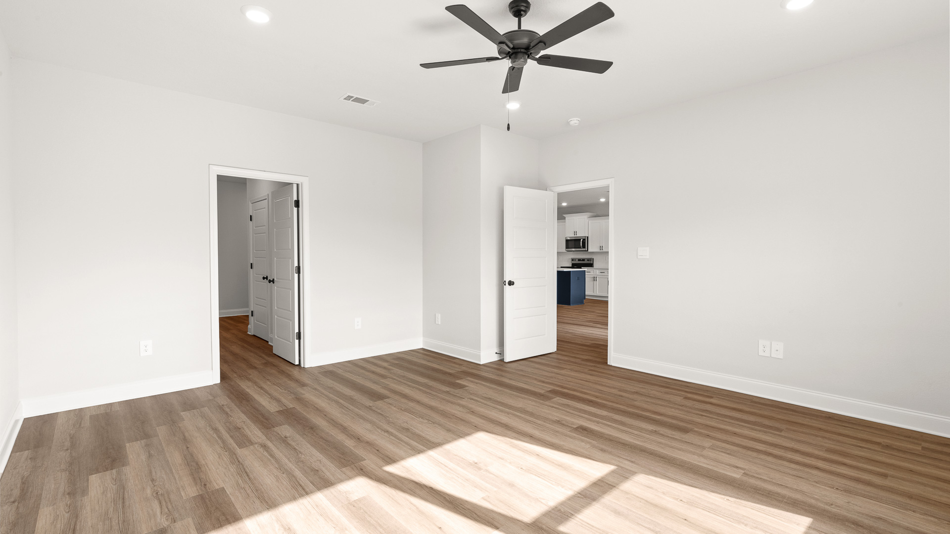 Large primary suite with tall ceilings and ceiling fan built by D.R. Horton.