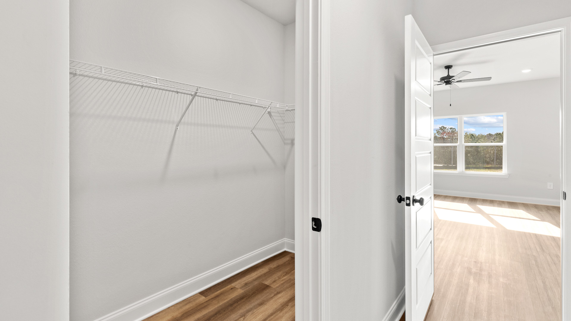 Primary walk in closet with ample storage space in Mobile County.