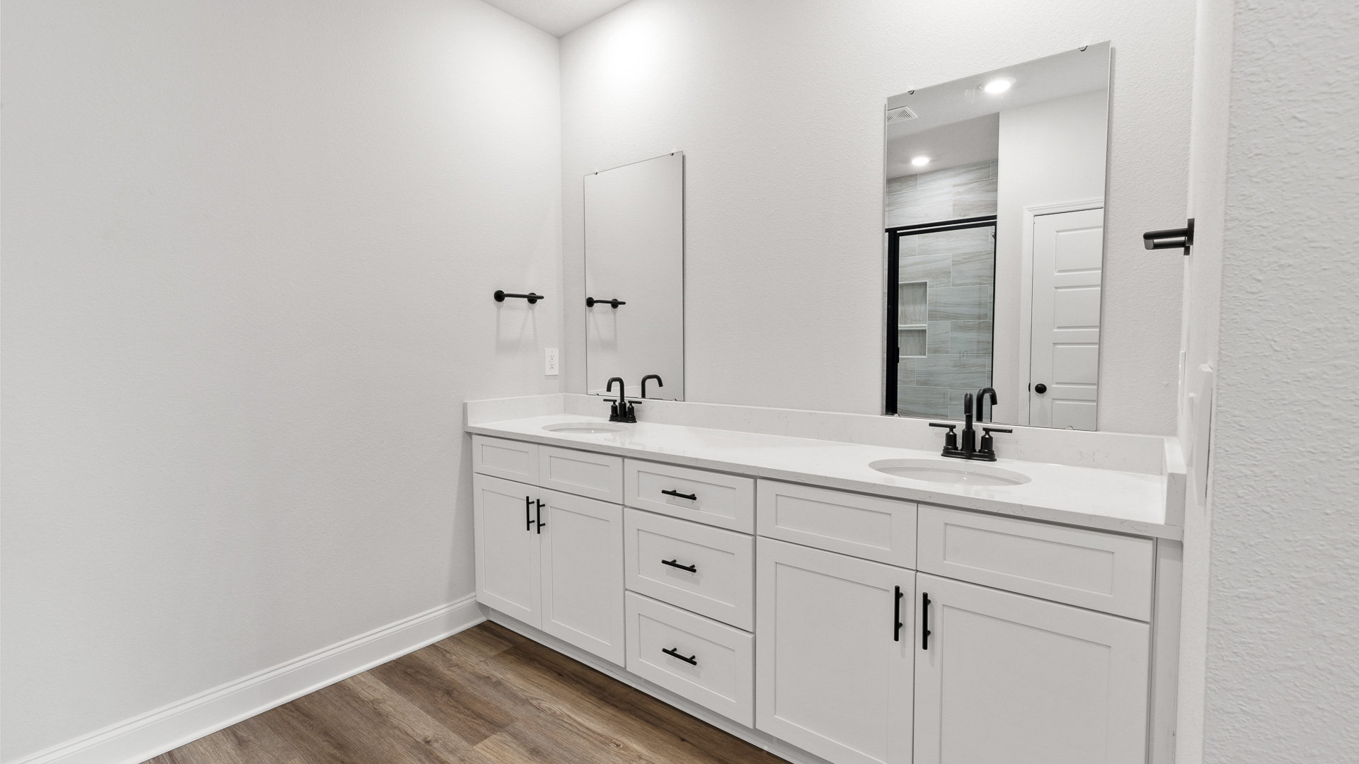 Primary en suite bathroom with double vanities and undermount sinks in a new D.R. Horton home in Alabama.