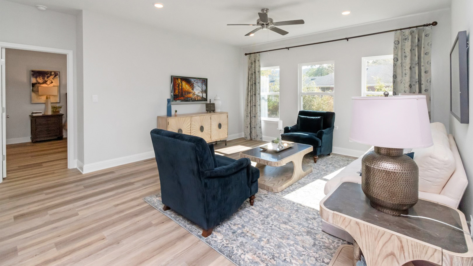 Open living area with luxury vinyl plank flooring and neutral color palette in Hawkins Manor.