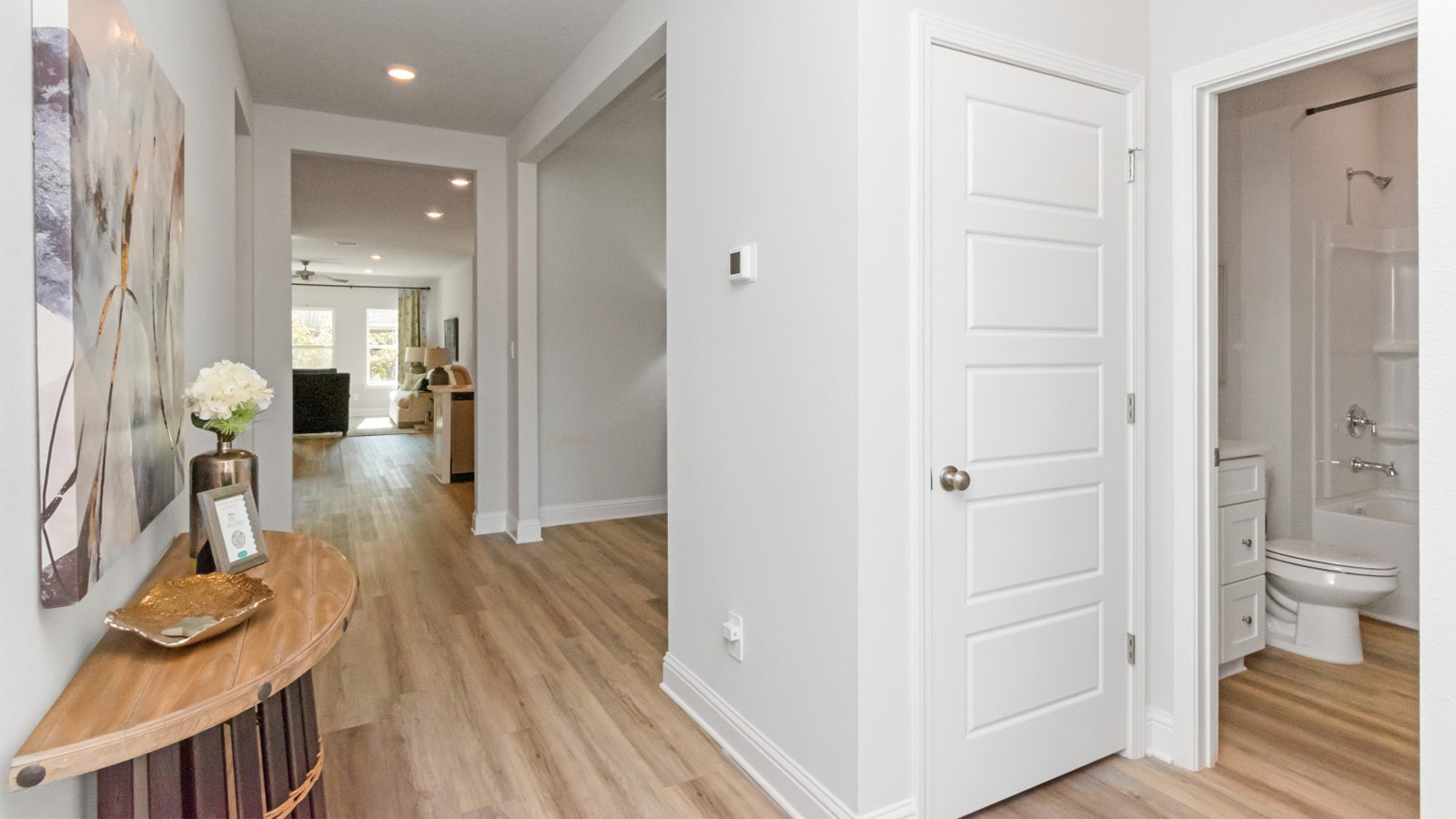 Entry hallway with neutral color palette and white trim in Hawkins Manor.