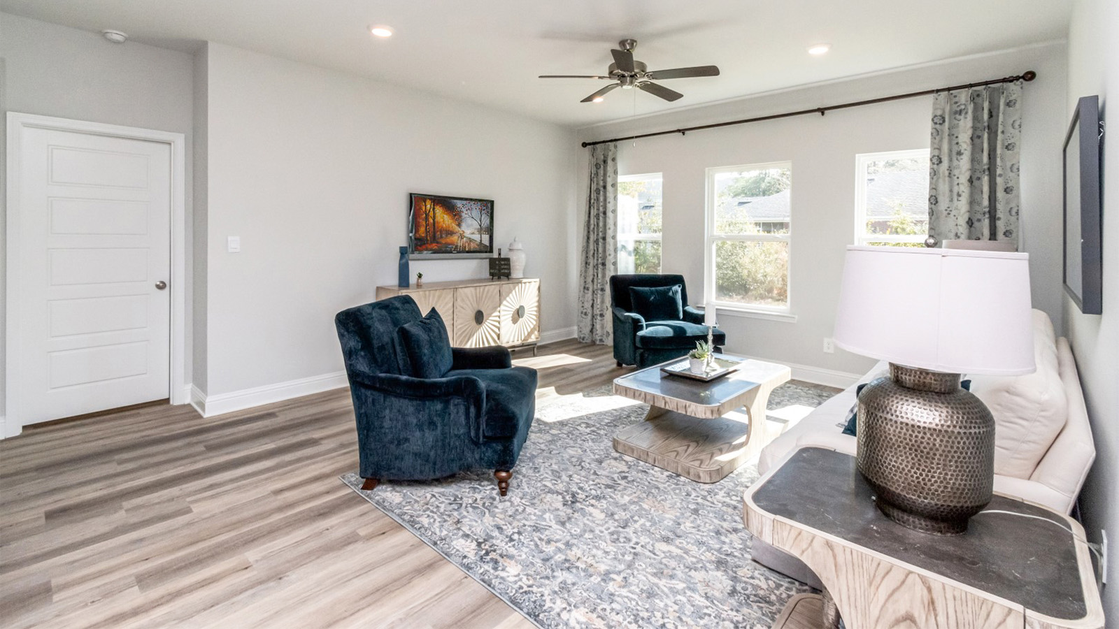 Family room with ceiling fan and cozy furnishings in Mobile County, Alabama.