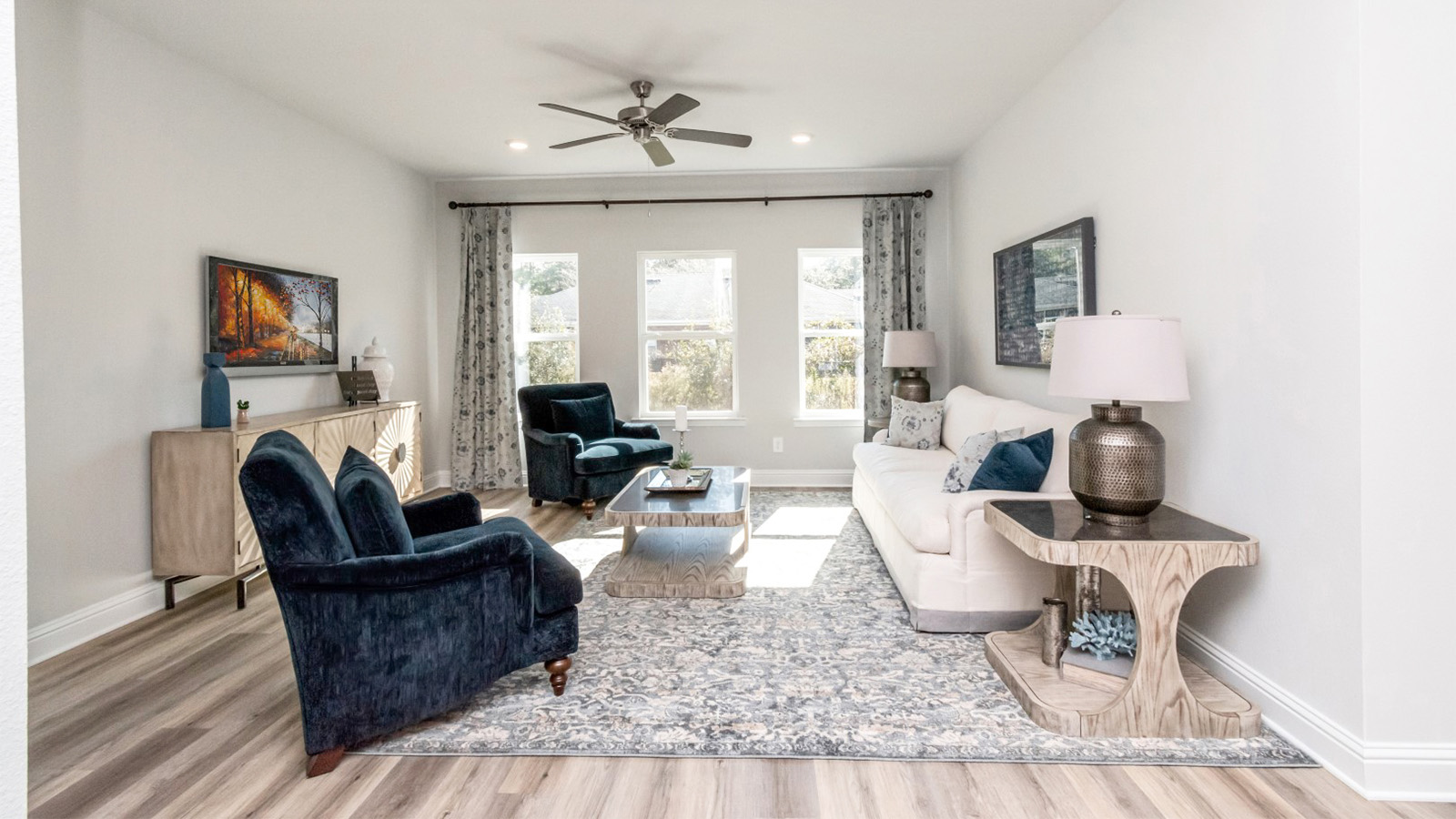 Family room with neutral furnishings and large windows for natural light in Mobile.