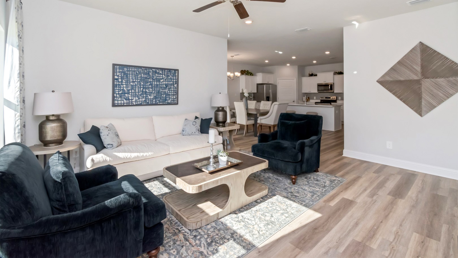 Family room with light walls and luxury vinyl plank flooring in Mobile.