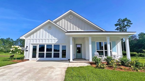 The Dover plan front elevation with white siding at Hawkins Manor
