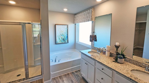 Cali primary bathroom with dual vanity, standing shower and garden tub.