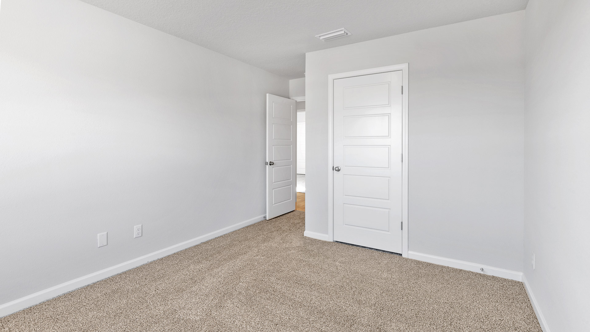 Guest bedroom with white trim and closet in Palmer Woods.