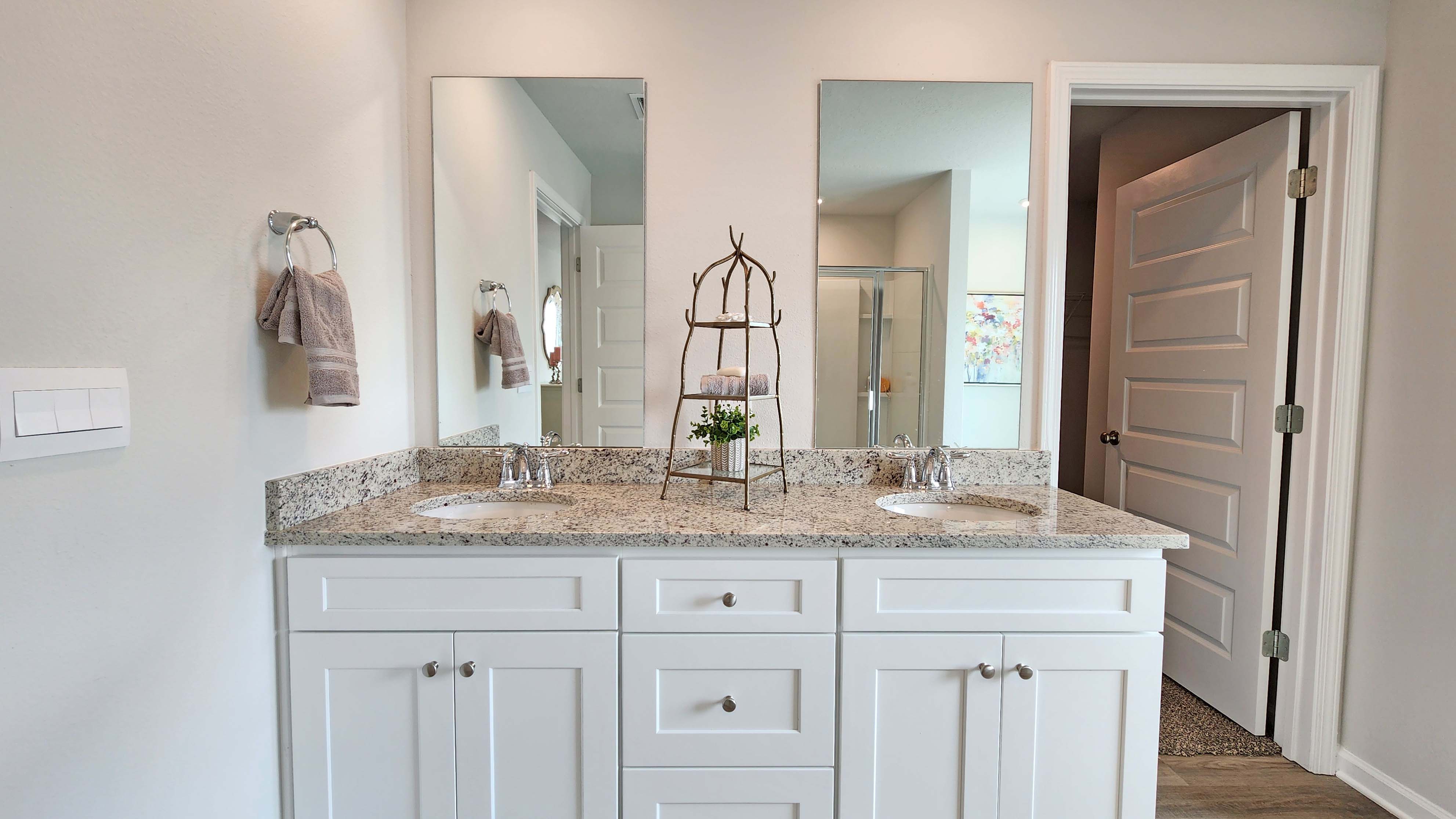 Bathroom with dual sinks and long mirrors above.