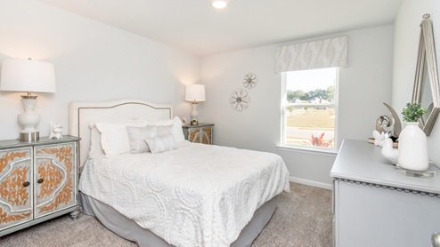 Secondary bedroom lit up with natural lighting