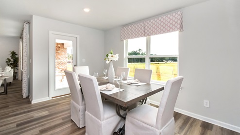 side view of lit up dining area by the kitchen