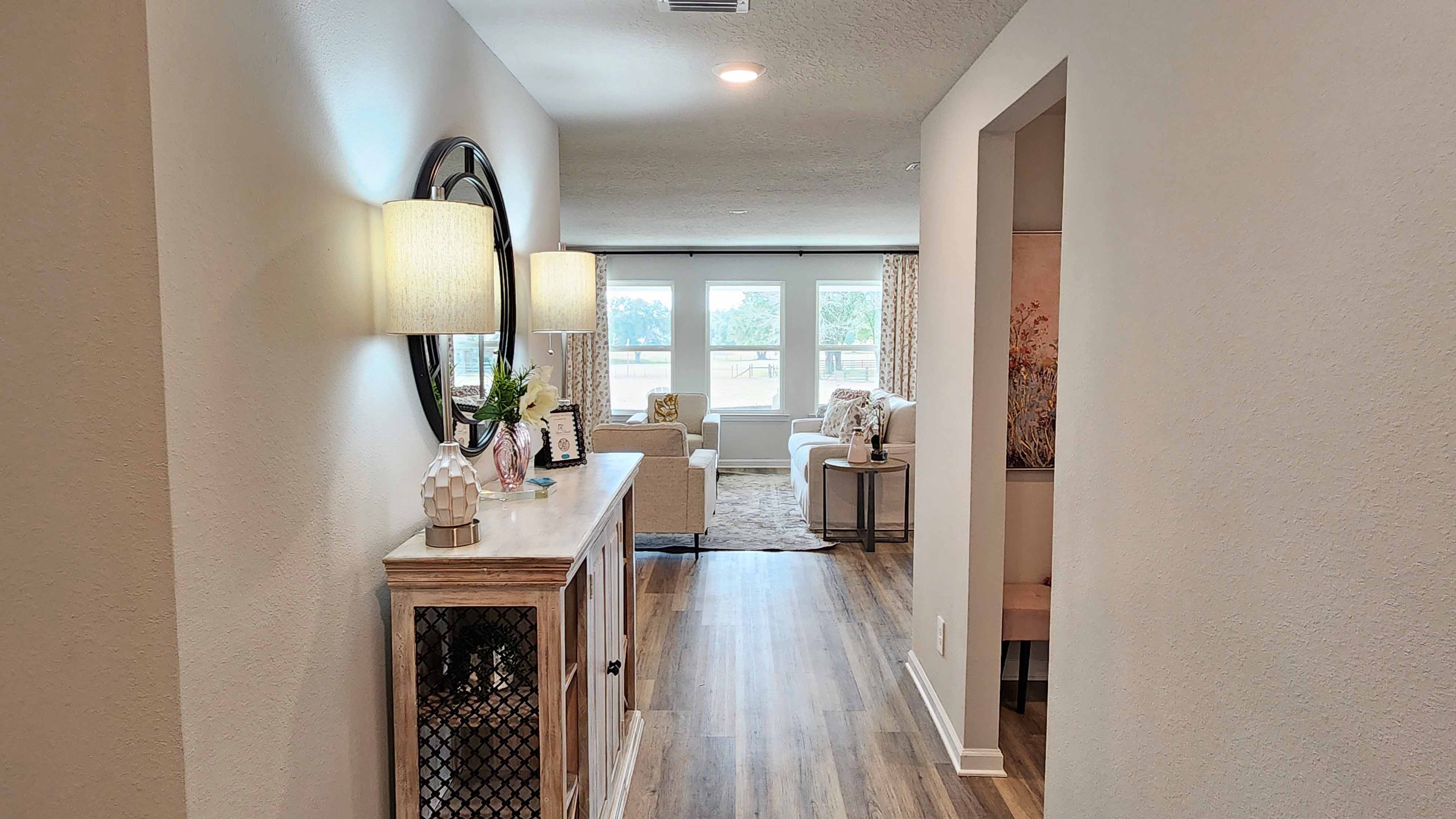 Long entry foyer with natural light into a new DR Horton home.