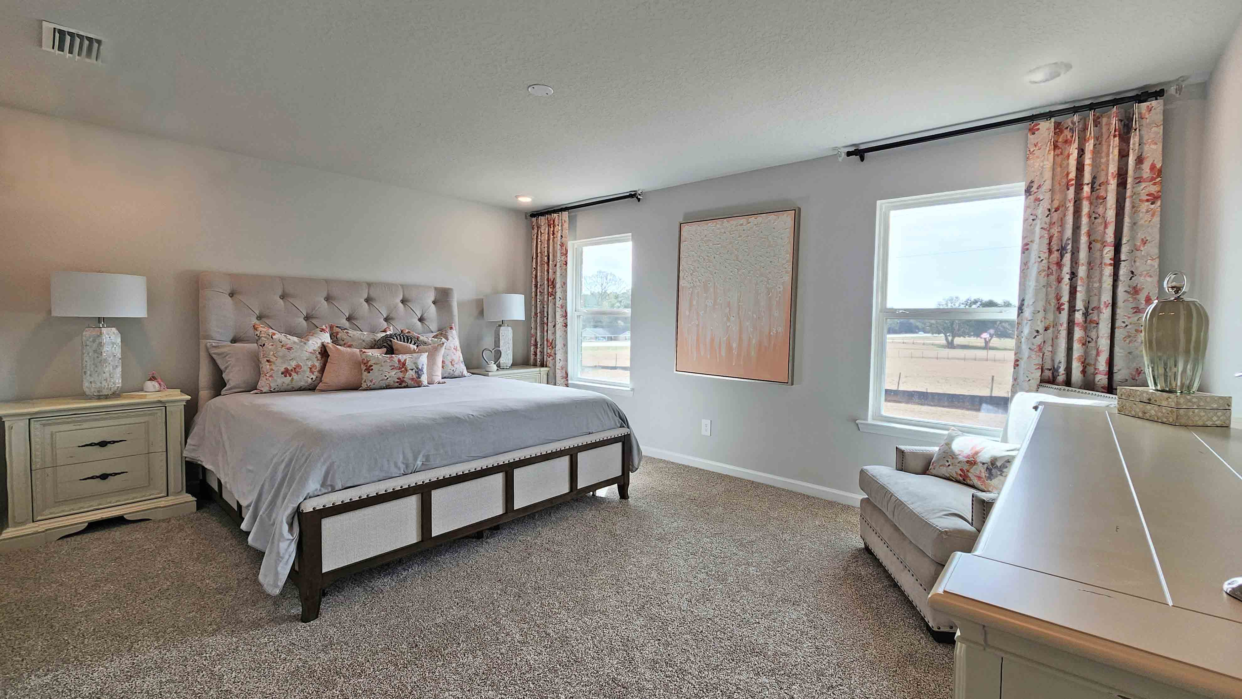 Spacious primary bedroom with natural light in a D.R. Horton home in Theodore, AL.
