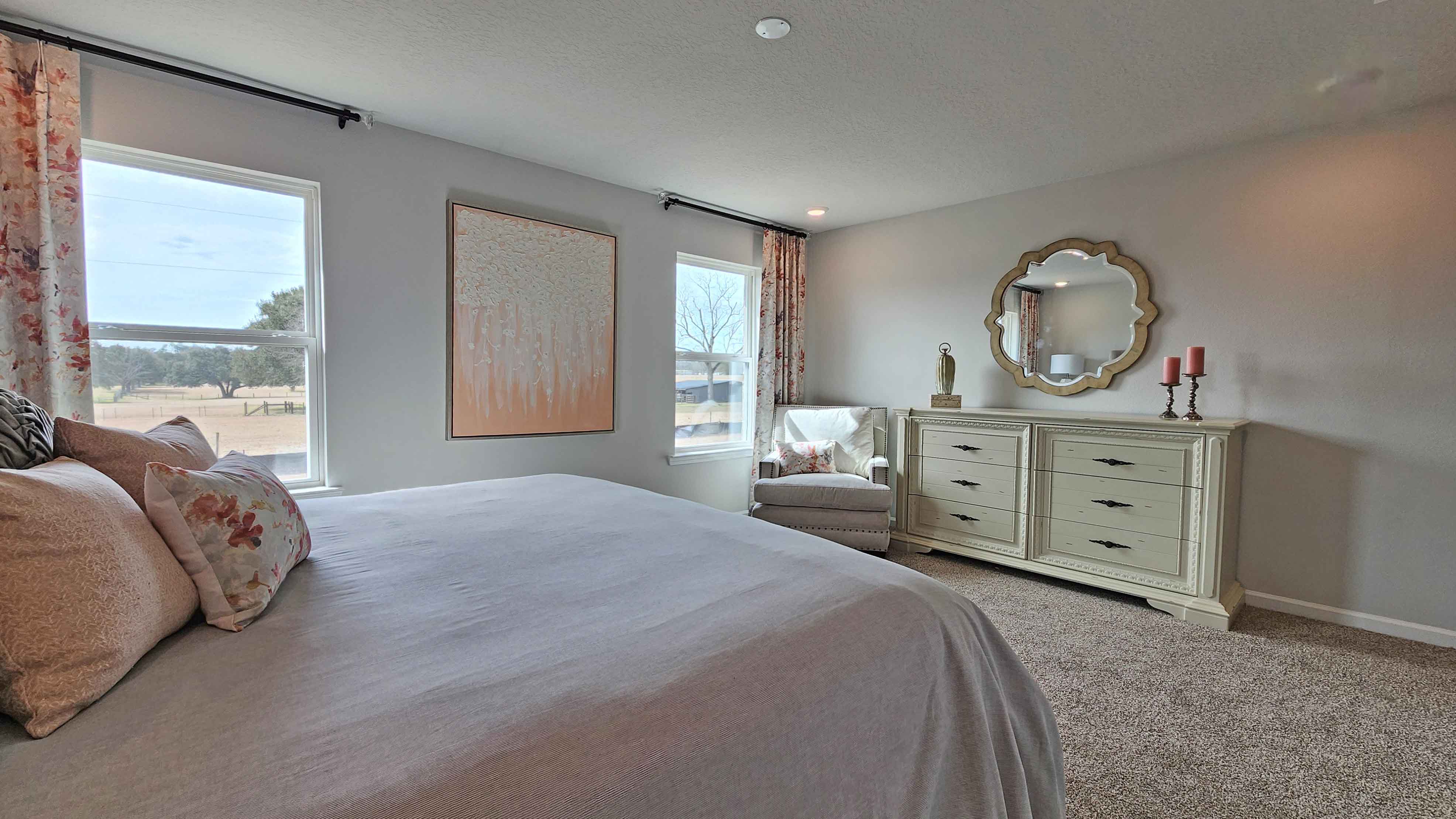 Spacious primary bedroom with natural light in a D.R. Horton home in Alabama.